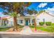 Inviting single-story home with desert landscaping, mature trees, and a charming turquoise front door at 2251 Van Gogh Dr, Henderson, NV 89074