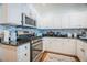 Well-lit kitchen with stainless steel appliances, granite countertops, and white cabinetry at 2251 Van Gogh Dr, Henderson, NV 89074