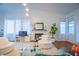 Comfortable living room with a fireplace, plush white seating, and abundant natural light, creating a serene atmosphere at 2251 Van Gogh Dr, Henderson, NV 89074