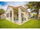 Charming covered patio with ample seating, perfect for outdoor gatherings and relaxation with green grass at 2251 Van Gogh Dr, Henderson, NV 89074