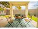 Cozy covered patio featuring a table, chairs, and comfortable outdoor seating area for relaxing and entertaining at 2251 Van Gogh Dr, Henderson, NV 89074