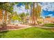 Beautiful community pool surrounded by lush landscaping and palm trees, offering a relaxing retreat at 2251 Van Gogh Dr, Henderson, NV 89074