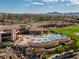 Beautiful aerial view of community pool area, well-manicured lawns, and impressive clubhouse at 2295 Otter Rock Ave, Henderson, NV 89044