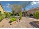 Landscaped backyard area with desert landscaping, a walkway, and ample space for gardening at 2295 Otter Rock Ave, Henderson, NV 89044