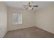Bedroom featuring a ceiling fan, plush carpet and plantation shutters at 2295 Otter Rock Ave, Henderson, NV 89044