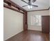 This room features a ceiling fan, built in shelves, wood flooring, and plantation shutters at 2295 Otter Rock Ave, Henderson, NV 89044