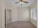 Carpeted bedroom with plantation shutters and a ceiling fan at 2295 Otter Rock Ave, Henderson, NV 89044