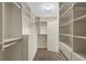 Walk-in closet with custom shelving and drawer unit at 2295 Otter Rock Ave, Henderson, NV 89044
