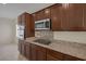 Kitchen features granite countertops, stainless steel appliances, and dark wood cabinets at 2295 Otter Rock Ave, Henderson, NV 89044