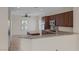 Well-lit kitchen featuring granite countertops and dark wood cabinetry at 2295 Otter Rock Ave, Henderson, NV 89044