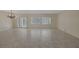 Spacious living room featuring tile floors, shuttered windows, and a chandelier at 2295 Otter Rock Ave, Henderson, NV 89044