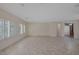 Bright, open living area with tile flooring and window with white shutters at 2295 Otter Rock Ave, Henderson, NV 89044