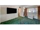 Bedroom has empty metal bed frame, wall-mounted TV, and glass door to patio at 2325 Sombrero Dr, Las Vegas, NV 89169