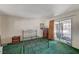 Bedroom features an empty metal bed frame, dresser and sliding glass doors to patio at 2325 Sombrero Dr, Las Vegas, NV 89169