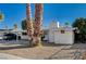 Street view of this charming single-story home featuring desert landscaping with a covered carport at 2325 Sombrero Dr, Las Vegas, NV 89169