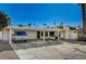 Driveway view of a single-story home with a covered carport and desert landscaping at 2325 Sombrero Dr, Las Vegas, NV 89169