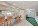 Bright kitchen with tile floors, light blue countertops, custom bar stools, and arched doorway at 2325 Sombrero Dr, Las Vegas, NV 89169