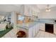 Bright kitchen boasts tile floors, light blue countertops, custom bar stools, and black appliances at 2325 Sombrero Dr, Las Vegas, NV 89169