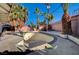 Backyard pool area with mature palm trees and blue skies at 2325 Sombrero Dr, Las Vegas, NV 89169