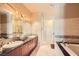 Bathroom with double sink vanity, granite countertop, soaking tub and walk-in shower at 2455 W Serene Ave # 923, Las Vegas, NV 89123