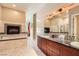 Luxurious bathroom boasts a tub, fireplace, mosaic tile and double sink vanity at 2455 W Serene Ave # 923, Las Vegas, NV 89123