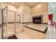 Modern bathroom featuring a walk-in shower, a soaking tub, and a fireplace at 2455 W Serene Ave # 923, Las Vegas, NV 89123