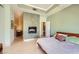 A modern bedroom with stone wall and fireplace is adjacent to the sink and vanity at 2455 W Serene Ave # 923, Las Vegas, NV 89123