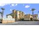 Exterior shot of Boca Raton condos with palm trees, a grand sign, and cobblestone entrance at 2455 W Serene Ave # 923, Las Vegas, NV 89123