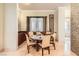 An inviting dining room with a round table, six chairs, and a window with sheer drapes at 2455 W Serene Ave # 923, Las Vegas, NV 89123