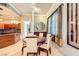 A modern dining room features a round table, chairs, and view into the kitchen at 2455 W Serene Ave # 923, Las Vegas, NV 89123