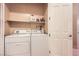 Convenient laundry room featuring a washer, dryer, and storage shelf at 2455 W Serene Ave # 923, Las Vegas, NV 89123