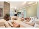 Open concept living room featuring tile floors, textured stone wall, and access to other living areas at 2455 W Serene Ave # 923, Las Vegas, NV 89123
