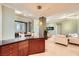 Spacious kitchen with dark cabinetry that opens up to dining and living room at 2455 W Serene Ave # 923, Las Vegas, NV 89123