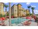Resort-style pool with ample lounge chairs and red umbrellas at 2455 W Serene Ave # 923, Las Vegas, NV 89123