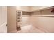 Spacious walk-in closet with ample shelving, and marble flooring provides space and organization at 2455 W Serene Ave # 923, Las Vegas, NV 89123