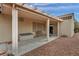 Covered back patio with bench and storage, plus a view of the easy-care landscaping at 2571 Thatcher Ave, Henderson, NV 89052