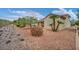 Spacious backyard featuring desert landscaping and a covered patio area at 2571 Thatcher Ave, Henderson, NV 89052