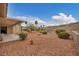 Expansive backyard with desert landscaping, privacy wall, and covered patio at 2571 Thatcher Ave, Henderson, NV 89052