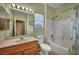 Bathroom features a vanity with a mirror, a toilet, and a shower/tub combination with a shower curtain at 2571 Thatcher Ave, Henderson, NV 89052