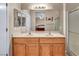 Bathroom featuring double sink vanity, large mirror, and shower with glass doors at 2571 Thatcher Ave, Henderson, NV 89052