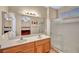 Bathroom featuring double sink vanity, large mirror, and shower with glass doors at 2571 Thatcher Ave, Henderson, NV 89052