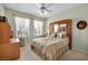 Comfortable bedroom featuring a ceiling fan and an eye-catching decorative headboard at 2571 Thatcher Ave, Henderson, NV 89052