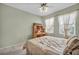 Comfortable bedroom with desk, ceiling fan, and view of the outside at 2571 Thatcher Ave, Henderson, NV 89052