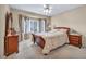 Carpeted bedroom featuring king bed and wooden furniture with natural lighting at 2571 Thatcher Ave, Henderson, NV 89052