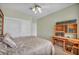 Cozy bedroom featuring a comfortable bed, built-in desk, closet and a ceiling fan at 2571 Thatcher Ave, Henderson, NV 89052