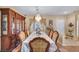 Elegant dining room featuring a chandelier and a long table with seating for eight at 2571 Thatcher Ave, Henderson, NV 89052