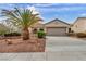 Charming single-story home with a desert landscape, a 2-car garage, and a well-maintained front yard at 2571 Thatcher Ave, Henderson, NV 89052