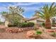 Charming single-story home featuring desert landscaping, mature trees, and a well-maintained exterior at 2571 Thatcher Ave, Henderson, NV 89052