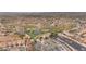 Aerial view of a lush green golf course nestled amongst homes in a desert landscape at 2571 Thatcher Ave, Henderson, NV 89052