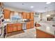 Well-lit kitchen featuring stainless steel appliances, tile flooring, and wood cabinetry at 2571 Thatcher Ave, Henderson, NV 89052
